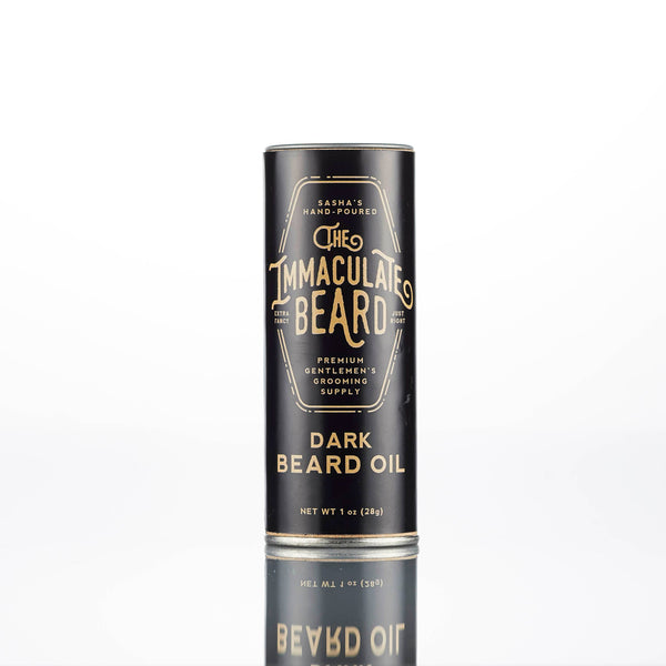 A black cylindrical container of "The Immaculate Beard DARK Beard Balm," a premium handmade grooming supply by The Immaculate Beard, stands upright on a plain white background.