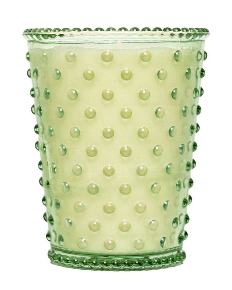 The Simpatico NO. 95 EUCALYPTUS Hobnail Glass Candle features a light green soy wax in a translucent, vintage-style holder with raised bumps, offering a unique and calming eucalyptus scent.