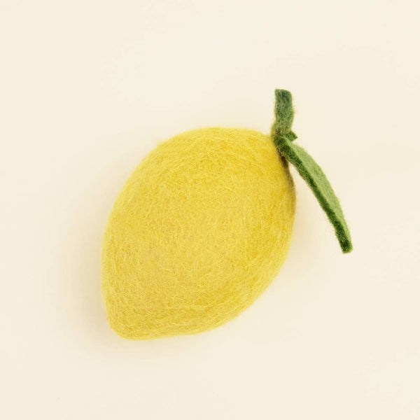 The MODERNBEAST Wool Lemon Dog and Cat Toy is a soft, yellow, felt lemon with a green leaf—an eco-friendly toy from MODERNBEAST that's gentle for your pet and the planet, set against a simple light background.