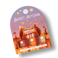 The Woolzies Sweet Autumn Collection packaging shows two smiling squirrels among pumpkins and autumn leaves. "Sweet Autumn" text appears, featuring three essential oils: Into the Woods, Orange, and Pumpkin Pie by Woolzies.
