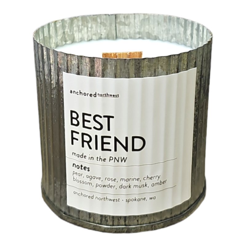 The "Anchored Northwest Best Friend Rustic Vintage Farmhouse Wood Wick Candle," created by Anchored Northwest using American-grown soy wax in the Pacific Northwest, showcases a fragrance blend of pear, agave, rose, marine, and additional notes. Housed in a rustic vintage metallic container accompanied by a wooden wick, it emanates warmth and charm.