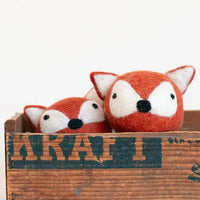 The MODERNBEAST Fox Beastball Wool Cat and Dog Toy features two handmade, natural wool balls styled as fox faces with orange fur, white cheeks, and black noses, packaged in a rustic wooden "KRAFT" box—perfect for playful pets.