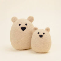 The MODERNBEAST Wool Polar Bear Dog Toy by MODERNBEAST features two beige wool felt bears, one large and one small, with round bodies and simple faces—an adorable handmade toy for your pet.