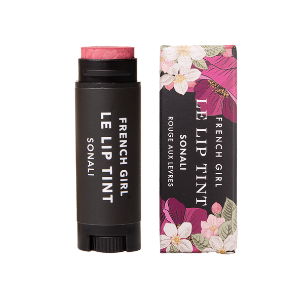 A tube of FRENCH GIRL Tinted Lip Balm in Sonali is displayed beside its floral-patterned box. Both feature the FRENCH GIRL brand name in white text on a dark background with pink and white flowers.