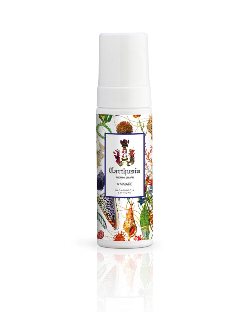A bottle of "Carthusia I Profumi de Capri" A'mmare Bath Foam with a vibrant label featuring botanical illustrations, including flowers and fruits, isolated on a white background, emits a luxurious scent.
