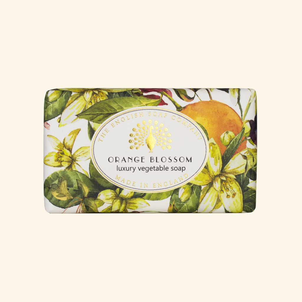 Rectangular soap package with vibrant illustrations of orange fruit and flowers labeled "The English Soap Co. Orange Blossom Vintage Wrapped Soap", luxury vegan-friendly soap.