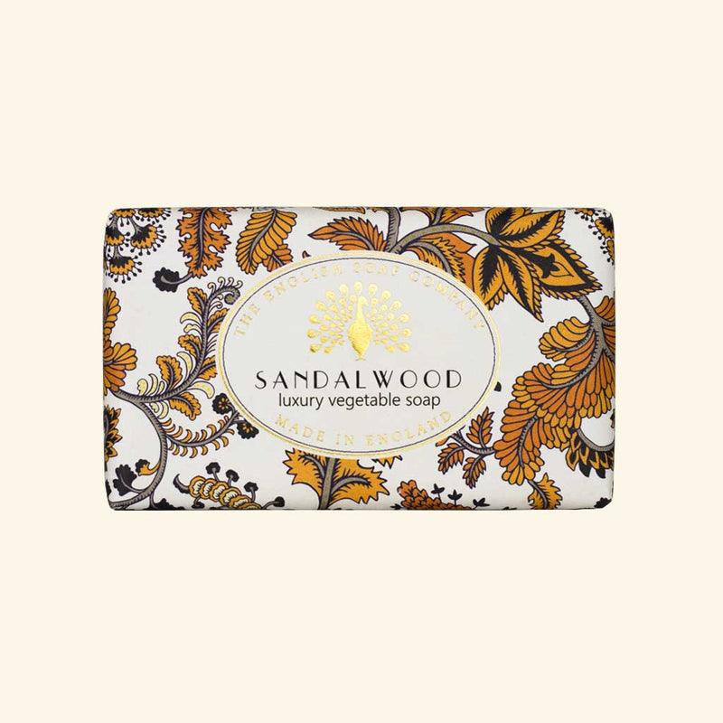 A rectangular package of The English Soap Co. Sandalwood Vintage Italian Wrapped Soap featuring an ornate floral pattern in shades of orange, black, and white. The text includes the brand and product type.