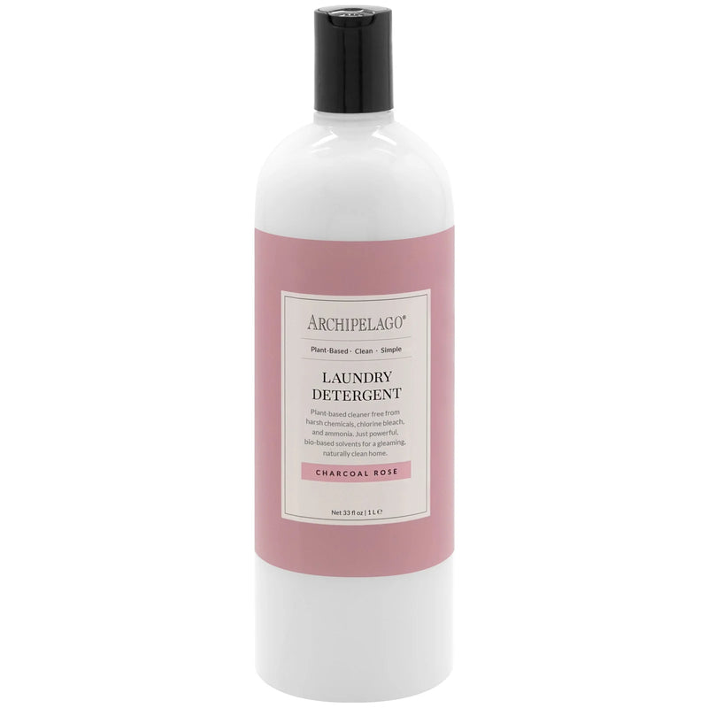 A bottle of Archipelago Charcoal Rose Laundry Detergent with bio-based ingredients. The bottle is white with a pink label and black text detailing the Archipelago Botanicals brand and fragrance.