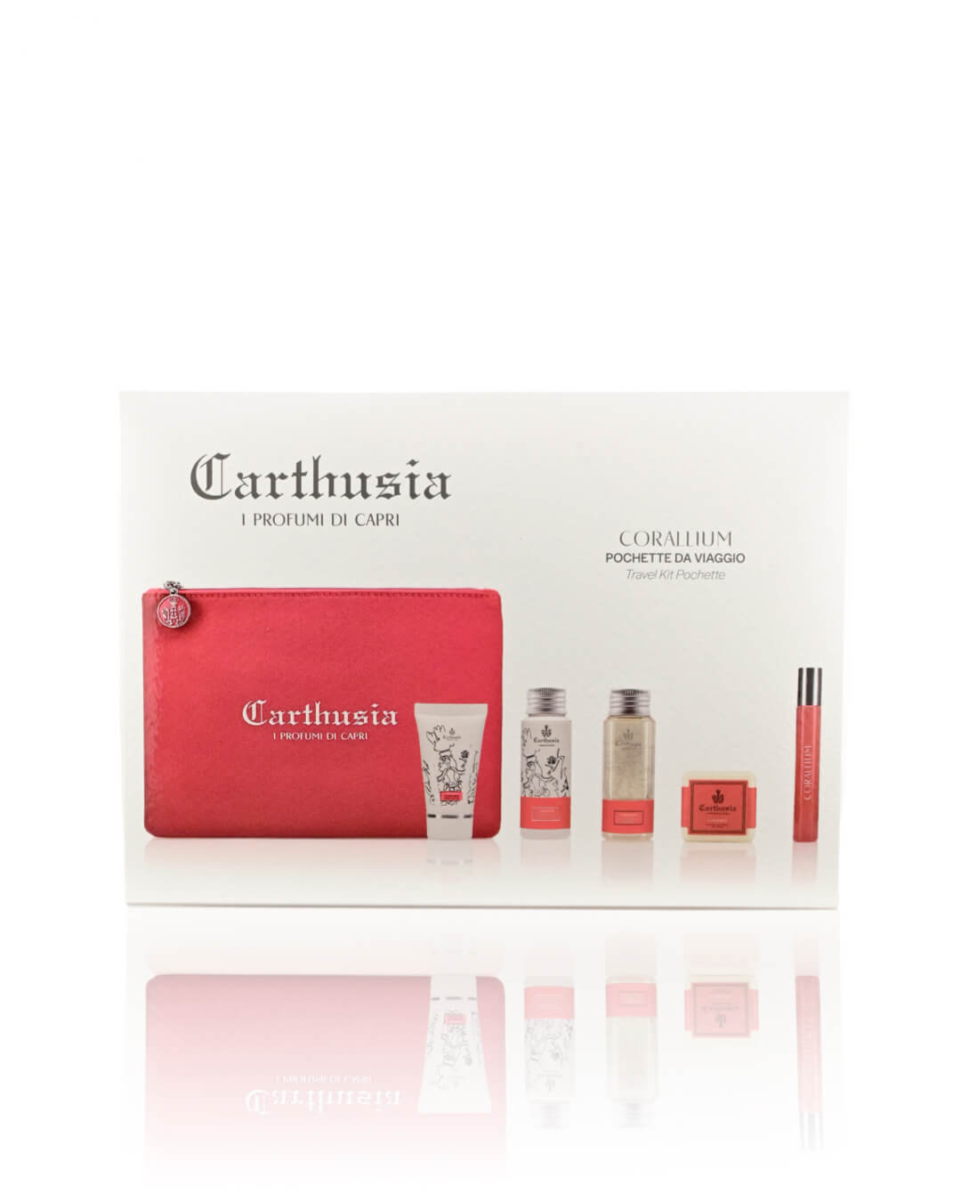 A beauty travel kit package labeled "Carthusia I Profumi de Capri, Carthusia Corallium Travel Clutch Bag." It includes a pink travel clutch bag and four beauty products such as lotions, sprays, and lip gloss. The design features white and red colors with decorative floral elements inspired by Carthusia Corallium's scented woods.