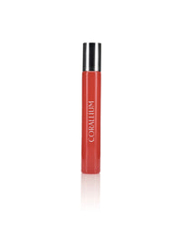 A tall, cylindrical red perfume bottle with a metallic silver cap. The bottle, named Carthusia Corallium Travel Clutch Bag by Carthusia I Profumi de Capri, has the word "CORALLIUM" printed vertically in white text down the front. Set against a plain white background, it evokes the essence of scented woods and fits perfectly into any travel clutch bag.