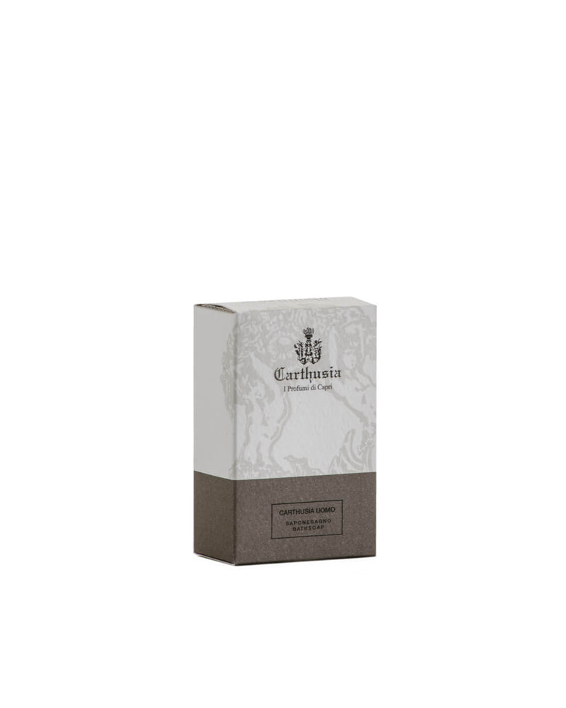 A box of Carthusia I Profumi de Capri Uomo Eau de Parfum with signature branding sits beside Carthusia Uomo Soap, both displayed against a plain white background. The soap is ideal for gentle cleansing and suitable for sensitive skin.