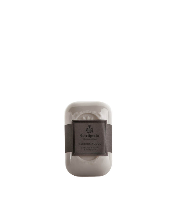 The Carthusia Uomo Soap by Carthusia I Profumi di Capri is a rectangular white bar with a decorative design, wrapped in a dark gray label. Centered on white, it's ideal for gentle cleansing and perfect for sensitive skin.