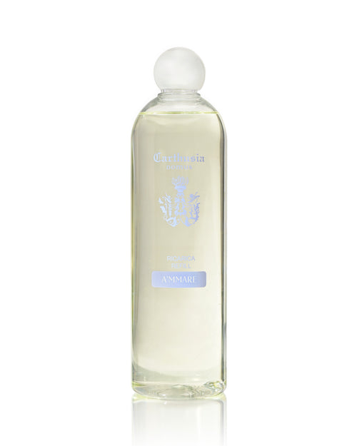 The Carthusia I Profumi di Capri A'mmare Reed Diffuser Refill (500ml) features a clear glass bottle with a rounded cap, light yellow liquid, and a crest logo label—perfect for infusing your home with a Capri-inspired luxury scent.