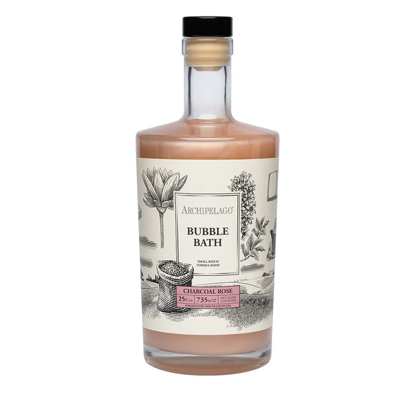 A clear 25 oz bottle of Archipelago Botanicals Charcoal Rose Luxury Bubble Bath with pink liquid, a botanical illustration label, and black cap.
