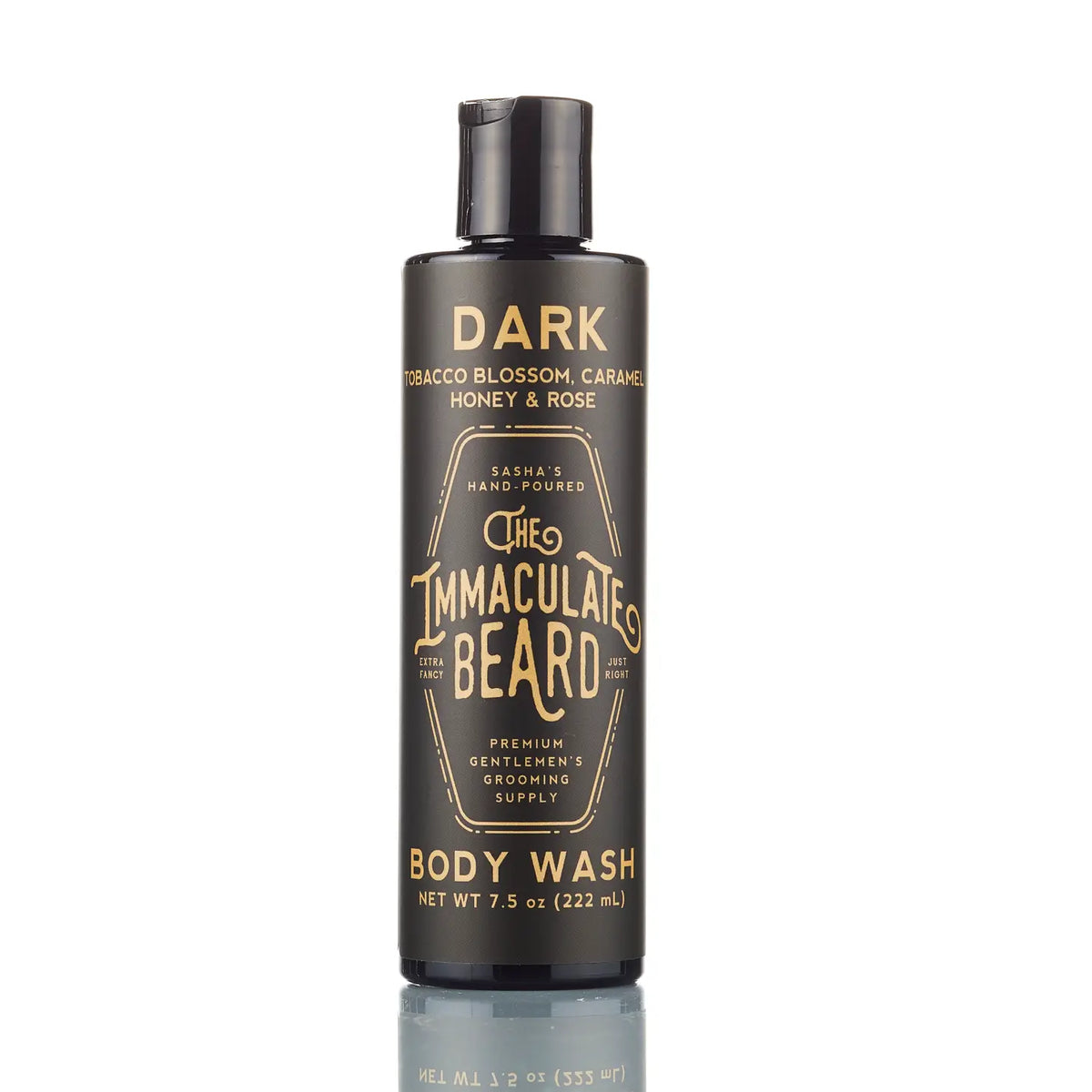 A black, tall, cylindrical bottle of "The Immaculate Beard" dark tobacco blossom, honey, and rose beard body wash. The container has white and gold text with a net weight of 7.