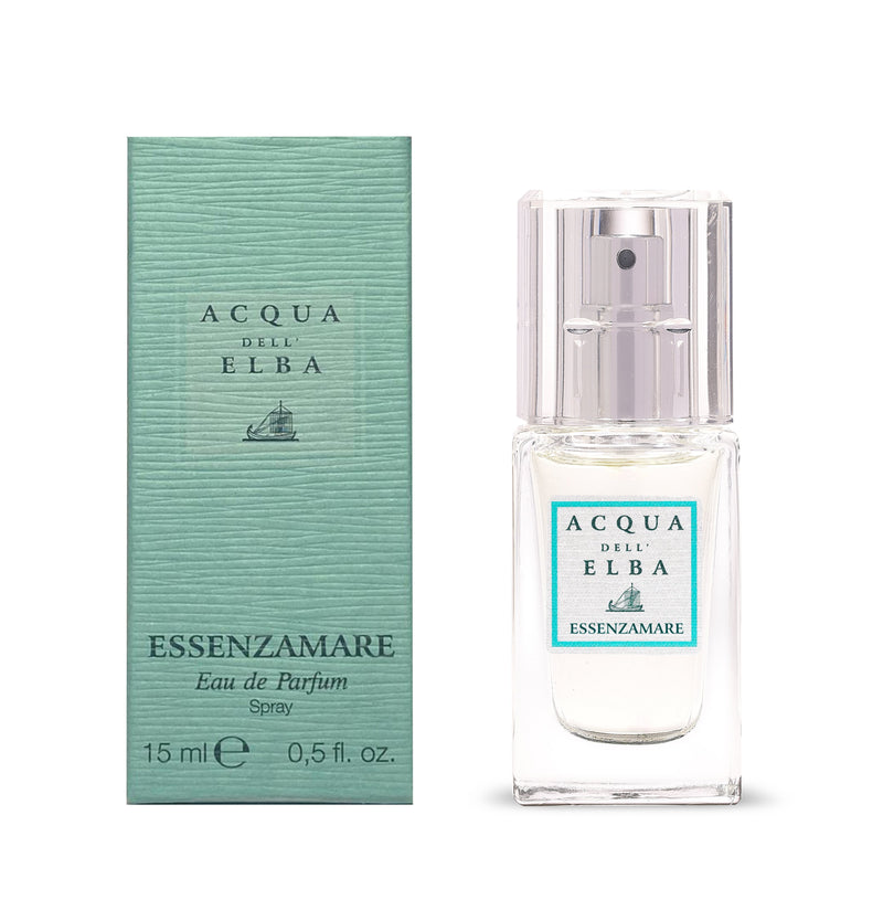 A 15ml Acqua dell'Elba Essenzamare EdP Travel Size stands by its turquoise box, both adorned with the brand’s logo and sailboat, reflecting the fragrance’s fresh floral marine character.