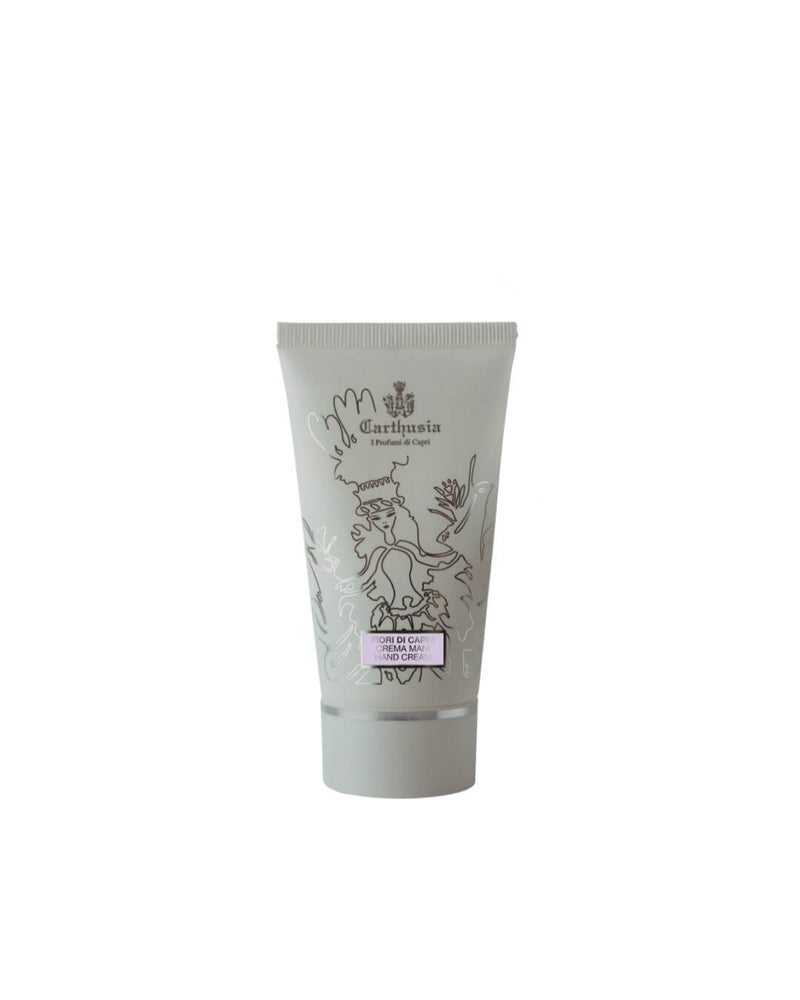 A tube of Carthusia Fiori di Capri hand cream with a decorative label featuring a stylized tree and a deer, enriched with shea butter, isolated on a white background.