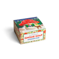 A vibrant package of Kala's Swedish Dream Gnome Soap in the delightful Swedish Pine fragrance, adorned with playful illustrations of gnomes, a red mushroom house, and a reindeer set against a snowy forest backdrop.