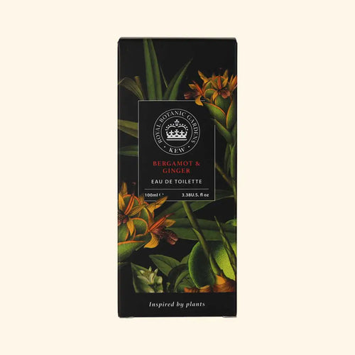 A rectangular box of The English Soap Co. Kew Gardens Bergamot and Ginger Eau de Toilette, a vegan fragrance made in England, with botanical leaf and flower illustrations on a black background and centered text.
