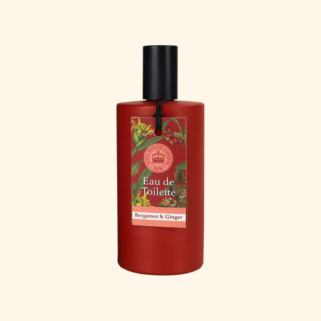 A red cylindrical bottle of The English Soap Co. Kew Gardens Bergamot and Ginger Eau de Toilette with a black cap features a floral label reading "Eau de Toilette" and "Bergamot & Ginger" against a light beige background.