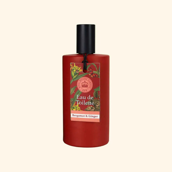 A red cylindrical bottle of The English Soap Co. Kew Gardens Bergamot and Ginger Eau de Toilette with a black cap features a floral label reading "Eau de Toilette" and "Bergamot & Ginger" against a light beige background.