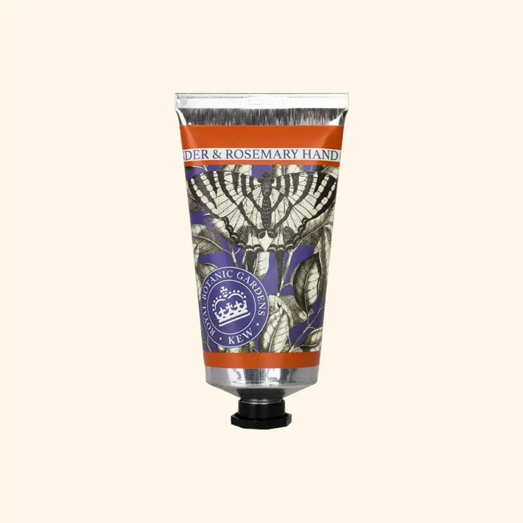 A silver tube of The English Soap Co. Kew Gardens Lavender and Rosemary Hand Cream with a black cap, botanical illustrations, and a purple-orange label sits against a beige background.