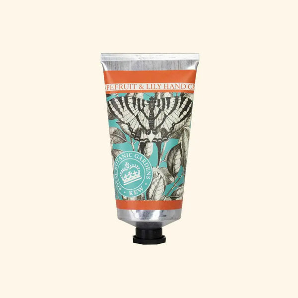 A silver tube of The English Soap Co. Kew Gardens Grapefruit and Lily Hand Cream offers intensive moisture, featuring vintage floral and butterfly artwork and labeled for sustainable luxury on the front.