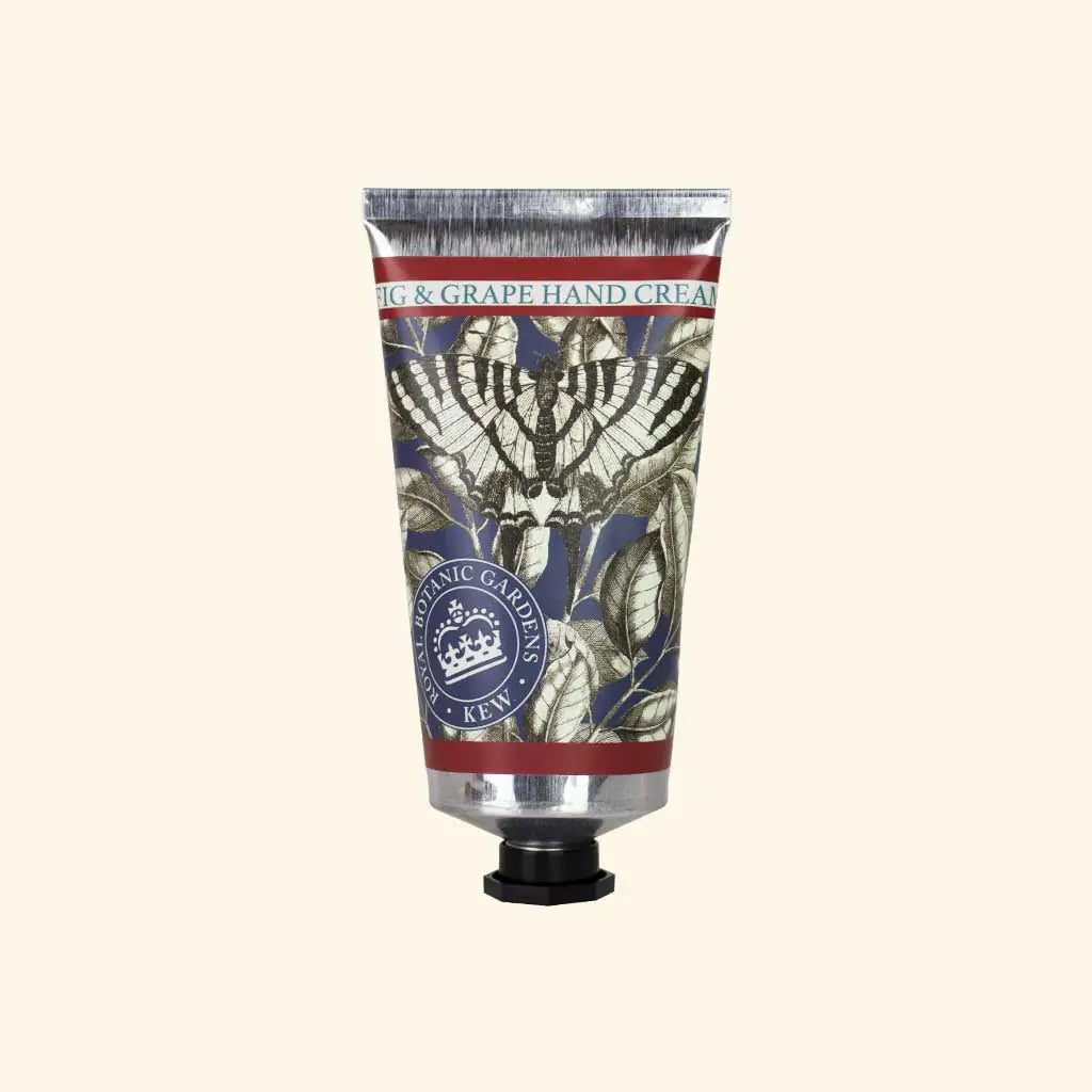 A metallic tube of The English Soap Co. Kew Gardens Fig and Grape Hand Cream features botanical illustrations, a dark screw cap, and a label with decorative leaf designs, highlighting British craftsmanship.