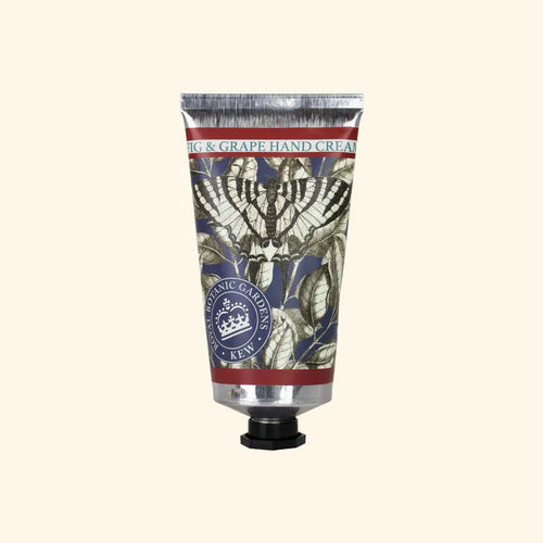 A metallic tube of The English Soap Co. Kew Gardens Fig and Grape Hand Cream features botanical illustrations, a dark screw cap, and a label with decorative leaf designs, highlighting British craftsmanship.