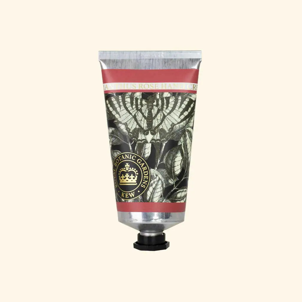 A silver and black floral tube of The English Soap Co. Kew Gardens Osmanthus Rose Hand Cream with a black cap, gold "Botanic Gardens KEW" seal, and pink label, displayed on a light beige background—luxury skincare from The English Soap Co.