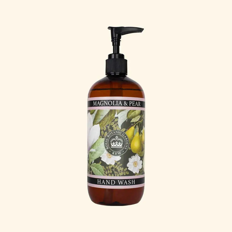 The English Soap Co. Kew Gardens Magnolia and Pear Hand Wash is a vegan hand wash in a brown pump bottle, featuring botanical illustrations of magnolia flowers and pears on a light cream label that captures the elegance of Kew Gardens.