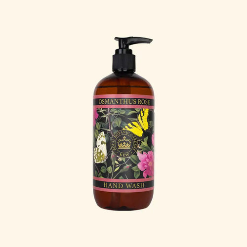 A brown pump bottle of The English Soap Co. Kew Gardens Osmanthus Rose Hand Wash, featuring floral and butterfly art on the label, sits on a light beige background—a vegan hand wash that adds elegance to your sink.