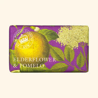 The English Soap Co. Kew Gardens Elderflower and Pomelo Soap is a vegan bar wrapped in purple paper with yellow pomelo, green leaves, elderflower blossoms, a circular Kew Gardens logo, and sustainable packaging.