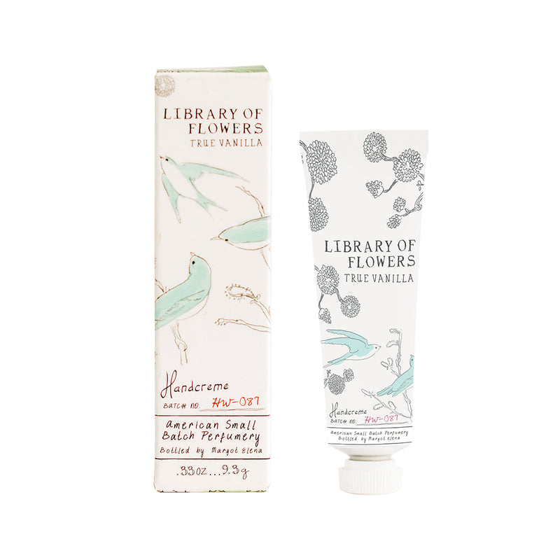 A tube and a box of Margot Elena's Library of Flowers True Vanilla Petite Treat Handcreme, enriched with Cocoa Butter, labeled "true vanilla," illustrated with botanical and bird drawings, on a white background.
