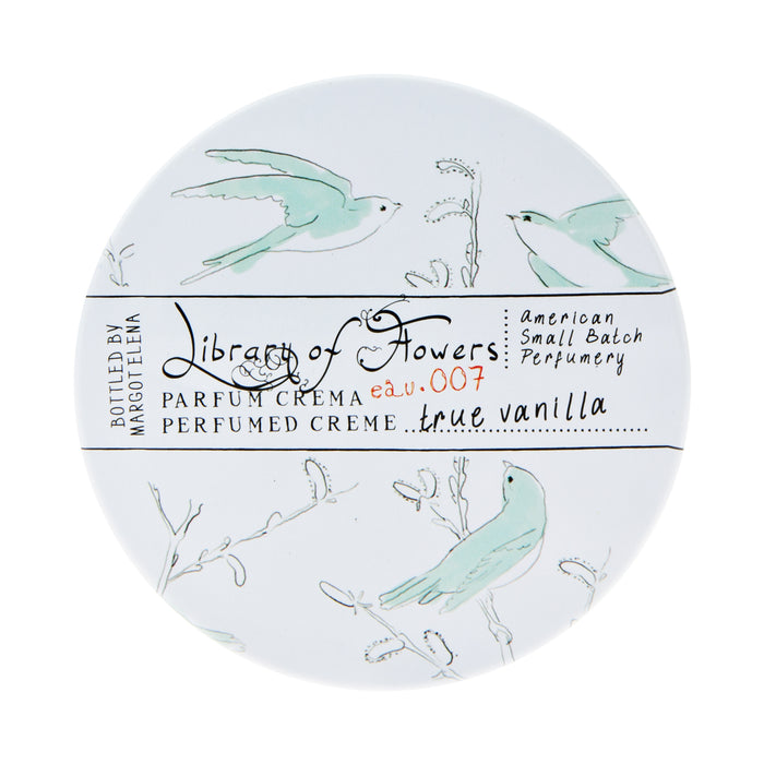 Round container of Margot Elena's Library of Flowers True Vanilla Parfum Crema featuring delicate illustrations of birds and floral elements on a white background, with text detailing the product scent as true vanilla. This triple-scented cream ensures a