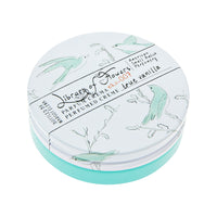 A round container of Library of Flowers True Vanilla Parfum Crema labeled "Margot Elena," featuring a teal lid with illustrations of birds and branches in a light sketch style on a white background.