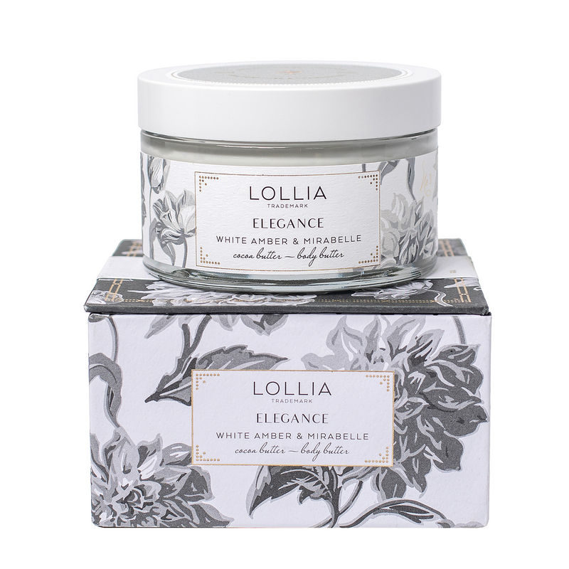 A container of Margot Elena Lolliia Elegance body butter in White Amber & Mirabell scent, sitting atop its matching floral-patterned box. The packaging is sophisticated with elegant silver and white designs.