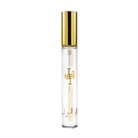 Elegant transparent perfume bottle with gold cap and logo, labeled "Margot Elena Lollia Always in Rose Travel Eau de Parfum," isolated on a white background.