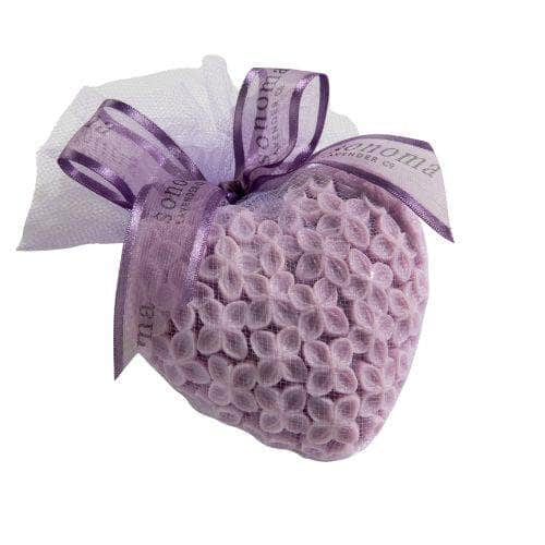 A heart-shaped lavender sachet of small fabric flowers, wrapped in tulle and tied with a purple ribbon, pairs beautifully with Sonoma Lavender Large Goats Milk Heart Soap for a delightful aromatic gift.