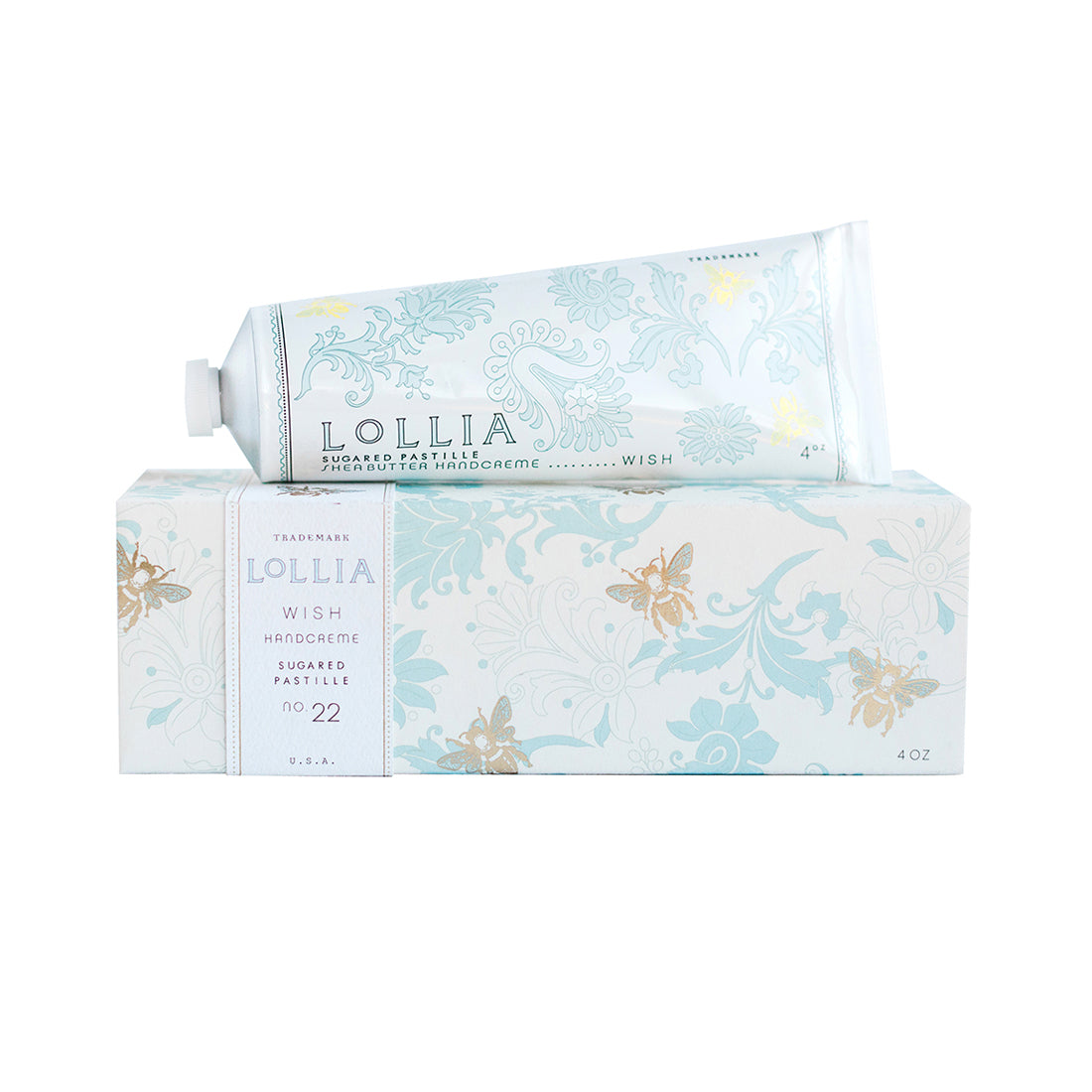 The Fast Bundle Lolia Wish Parfum Bundle features a tube of shea butter handcream (4 oz) atop its matching decorative box with light blue floral designs, gold accents, and descriptive text.
