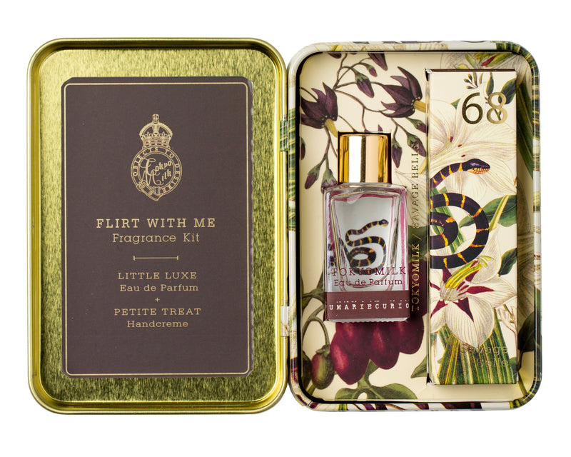 An open gift box displaying a TokyoMilk Savage Belle Flirt With Me Fragrance Kit labeled "Margot Elena." The kit includes a bottle of eau de parfum and a tube of hand cream, with floral designs on.