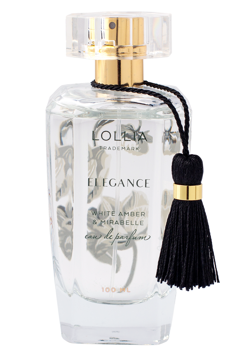 A transparent glass perfume bottle with a golden cap and a black tassel, labeled "Lollia Elegance Eau de Parfum", on a solid white background by Margot Elena.