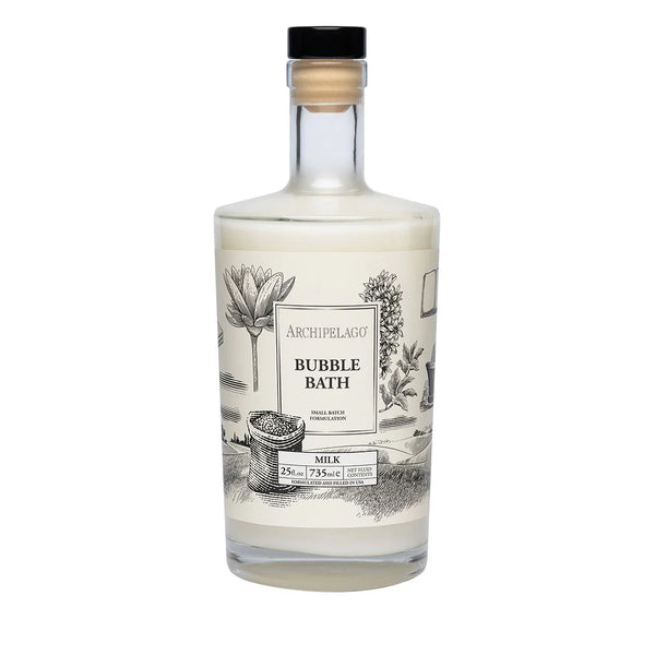 A clear 25 oz. bottle of Archipelago Botanicals Milk Luxury Bubble Bath, featured in Oprah’s Favorite Things 2024, with a black and white botanical illustration and cork stopper contains skin-soothing formula.
