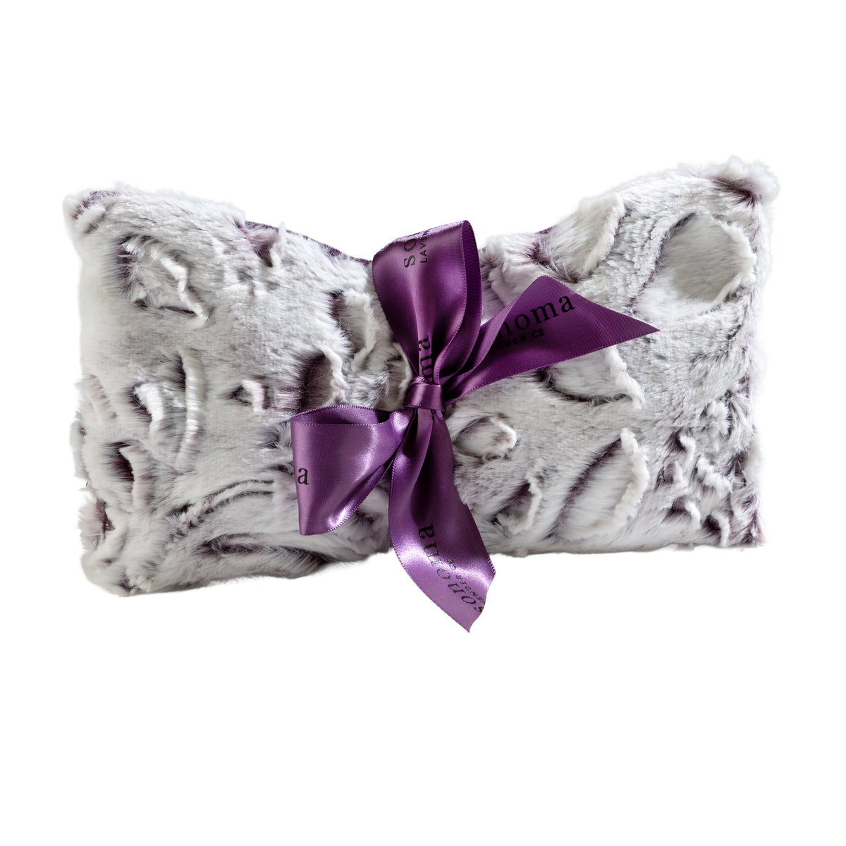 The Sonoma Lavender Iced Plum Spa Mask pairs perfectly with a soft, rectangular faux fur pillow featuring gray accents and a shiny purple ribbon bow with black writing—a plush duo for ultimate relaxation.