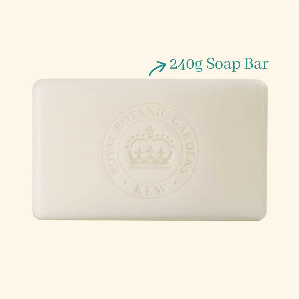 A rectangular ivory bar, embossed with a crown and "Royal Botanic Gardens Kew," sits beside text reading "240g Soap Bar" with an arrow pointing to the vegan The English Soap Co. Kew Gardens Sandalwood & Pink Pepper Soap.