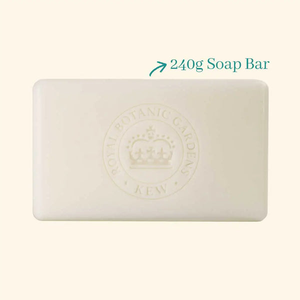 A rectangular ivory bar, embossed with a crown and "Royal Botanic Gardens Kew," sits beside text reading "240g Soap Bar" with an arrow pointing to the vegan The English Soap Co. Kew Gardens Sandalwood & Pink Pepper Soap.