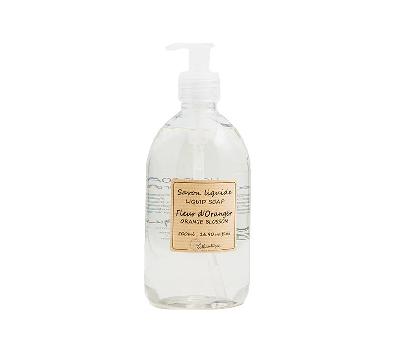A clear plastic pump bottle labeled "Lothantique Orange Blossom Liquid Soap, 500ml" contains transparent Marseille liquid hand soap with a delicate orange blossom scent by Lothantique.