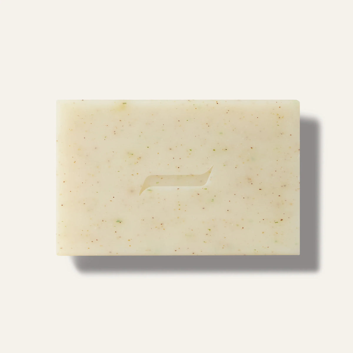 The Caswell-Massey Patchouly and Pine Bar Soap by Caswell Massey is a rectangular, off-white botanical soap with brown and green specks and a curved center indentation, displayed on a light background.