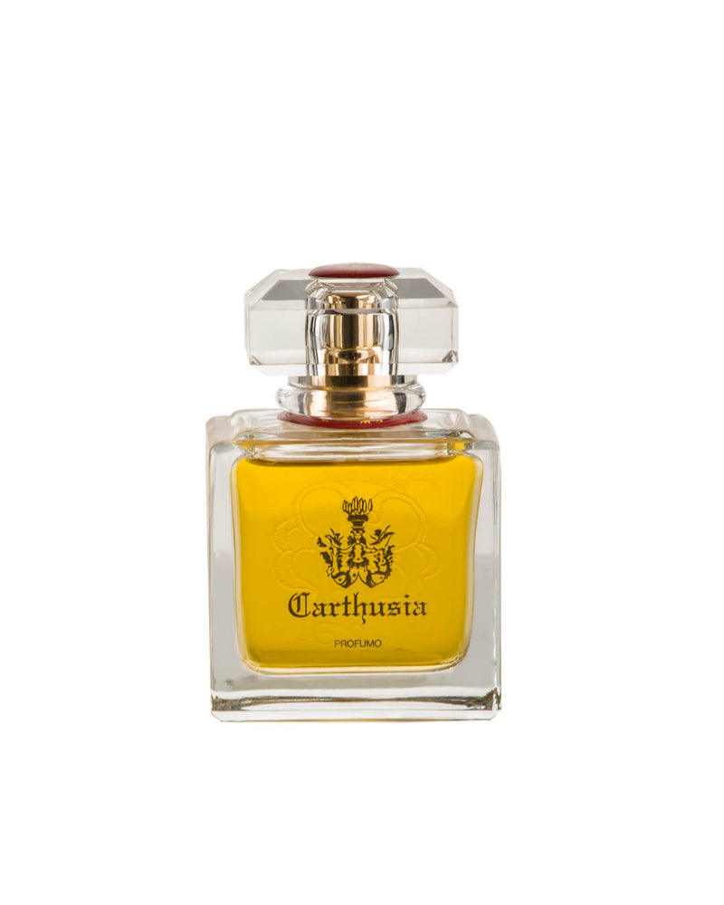 A clear glass bottle of yellow Carthusia Prima del Teatro di San Carlo Parfum by Carthusia I Profumi de Capri, featuring a square faceted cap, gold accents, and a front label with the Carthusia logo and black text.