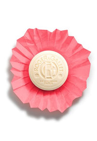 A set of three Roger & Gallet Red Ginger Wellbeing Soaps (3 x 3.5 oz), each round soap wrapped in pleated pink paper with an embossed logo, highlights French craftsmanship and natural ingredients, displayed on a white background.